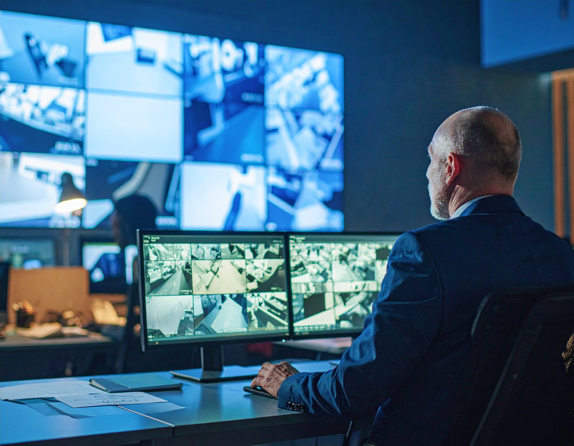 Firefly_show me a man looking at survaillane footage in an office setting, catching an cashie 255639